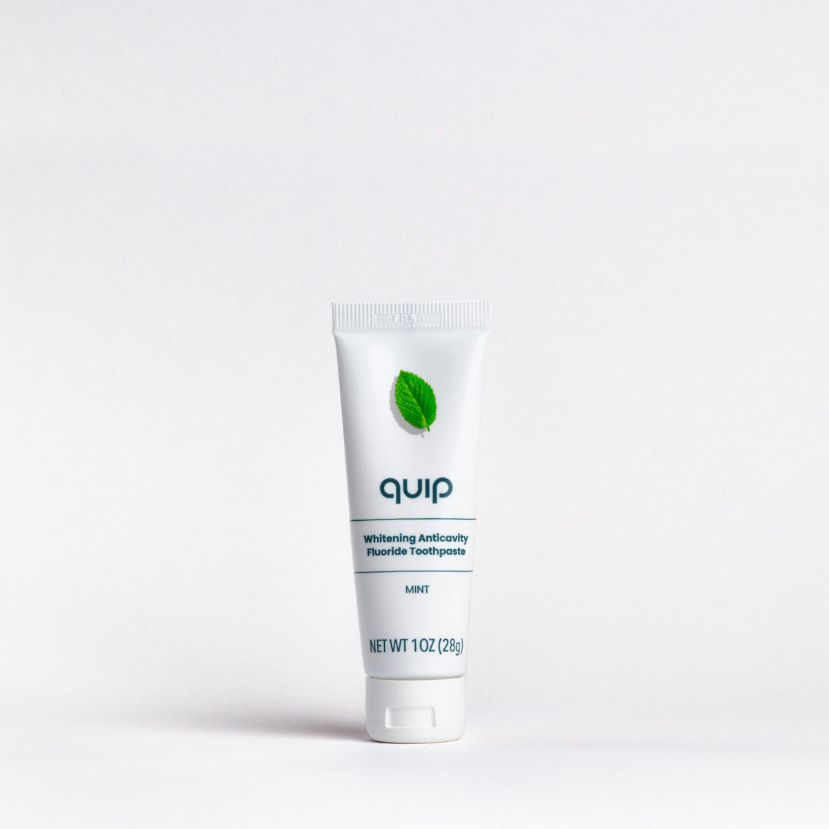Tube of 'quip' toothpaste on a white background